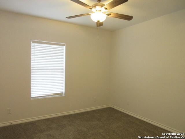 carpeted empty room featuring ceiling fan