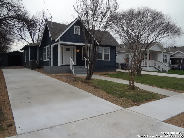 bungalow featuring central AC and a porch