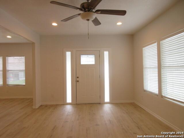 entrance foyer with ceiling fan, plenty of natural light, and light wood-type flooring