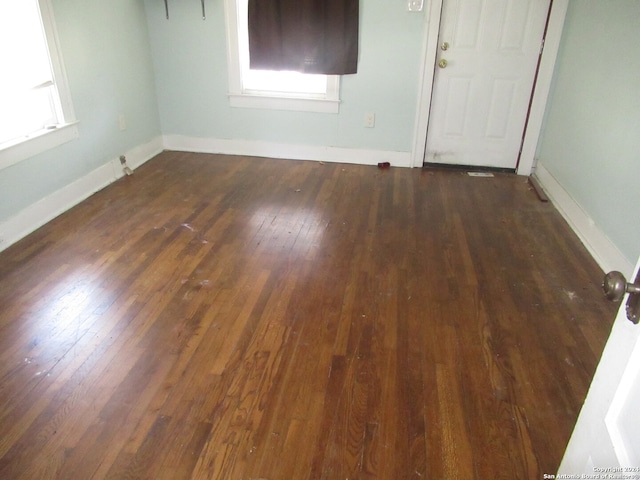 spare room featuring dark wood-type flooring