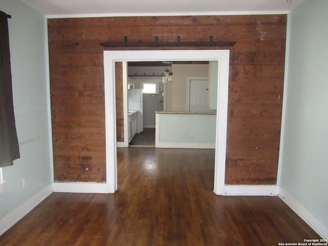 unfurnished room featuring dark hardwood / wood-style flooring