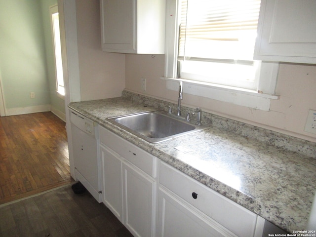 kitchen with dishwasher, plenty of natural light, dark hardwood / wood-style flooring, and white cabinetry