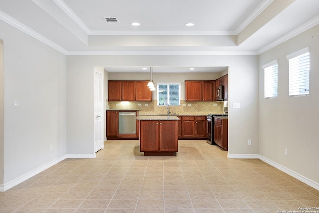 kitchen with a wealth of natural light, hanging light fixtures, backsplash, a tray ceiling, and appliances with stainless steel finishes