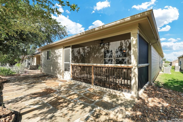 view of side of property featuring central AC, ceiling fan, and a patio