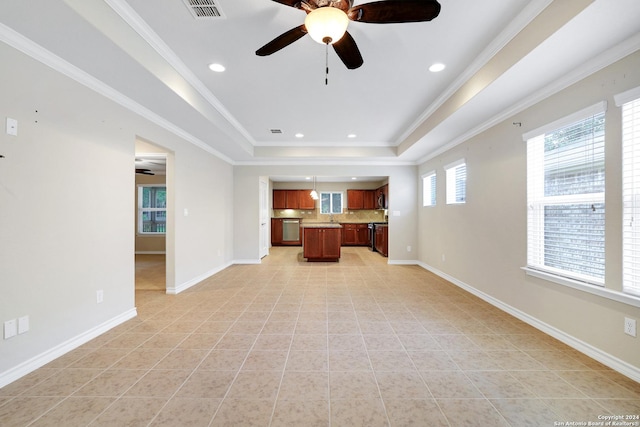 unfurnished living room featuring a raised ceiling, ceiling fan, light tile patterned flooring, and ornamental molding