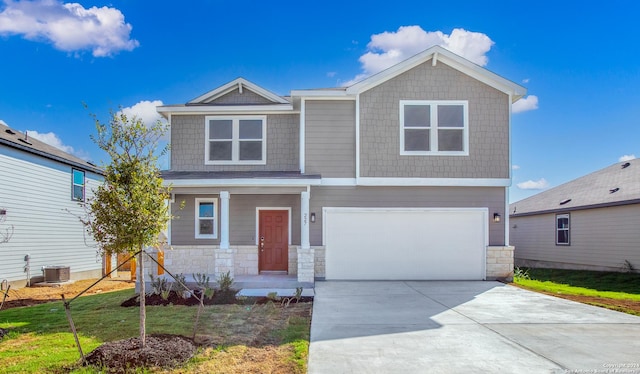 view of front of house featuring a front yard, a garage, and central AC unit