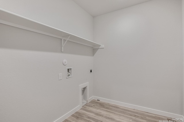 clothes washing area with hookup for a gas dryer, electric dryer hookup, hookup for a washing machine, and light wood-type flooring