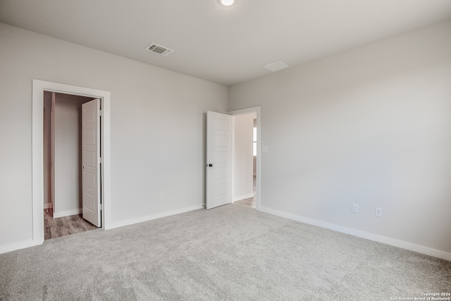 empty room with light colored carpet