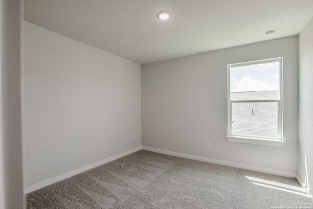 unfurnished room featuring light carpet