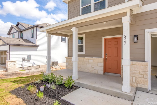 entrance to property featuring cooling unit and covered porch