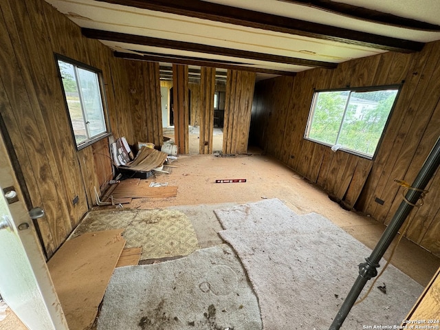 interior space with plenty of natural light and beam ceiling