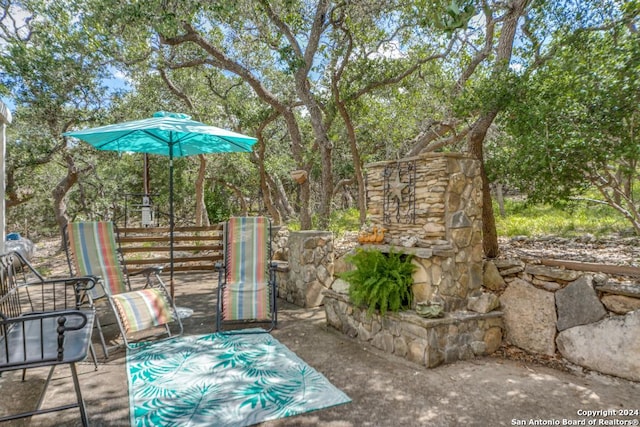 view of patio with an outdoor stone fireplace