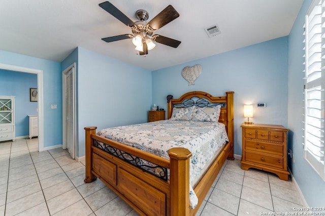 tiled bedroom with a closet and ceiling fan