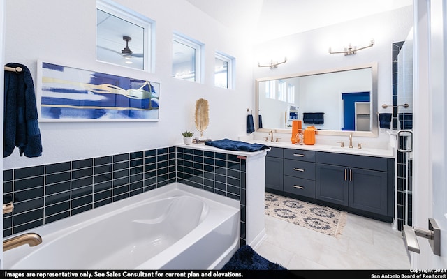 bathroom featuring tile flooring, vanity, ceiling fan, and a bath to relax in