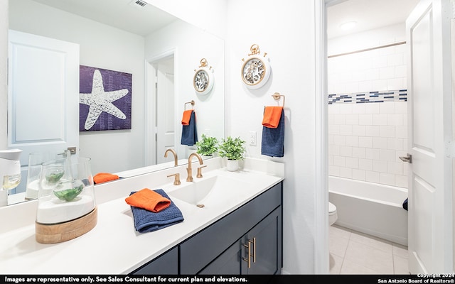 full bathroom featuring tiled shower / bath combo, tile flooring, toilet, and vanity