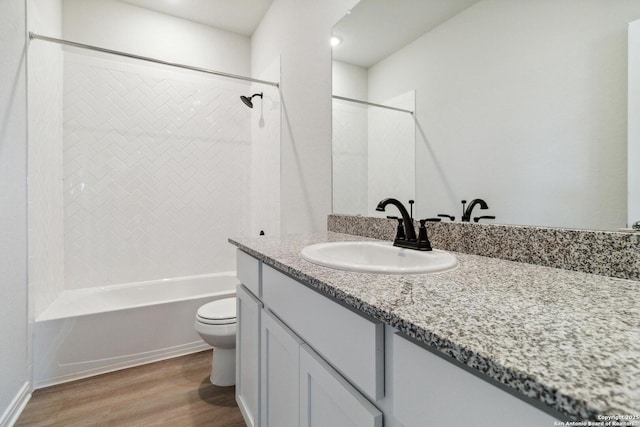 full bathroom with vanity, toilet, wood-type flooring, and shower / washtub combination