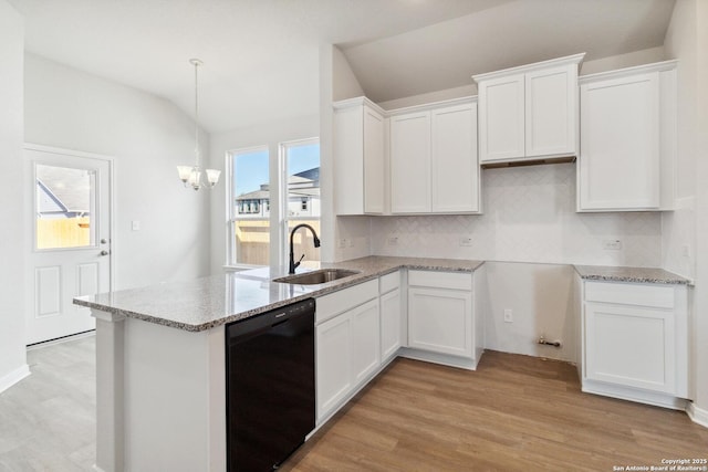 kitchen with white cabinets, sink, lofted ceiling, and black dishwasher