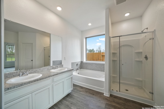 bathroom featuring hardwood / wood-style flooring, vanity, and independent shower and bath