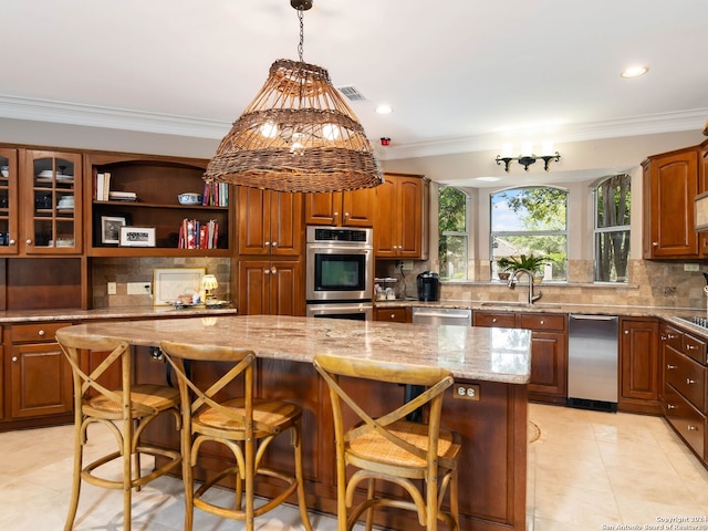 kitchen featuring tasteful backsplash, appliances with stainless steel finishes, a kitchen breakfast bar, and a kitchen island