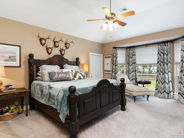 bedroom with light carpet, ceiling fan, and lofted ceiling