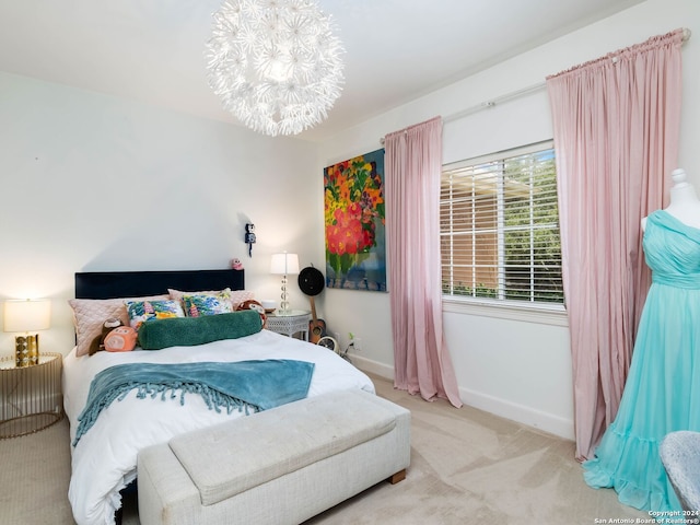 carpeted bedroom featuring an inviting chandelier