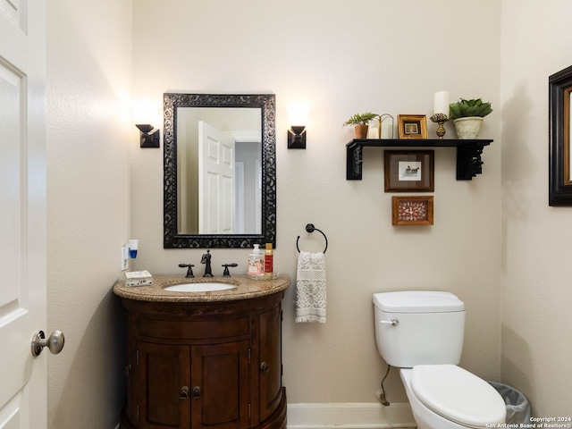 bathroom featuring toilet and vanity