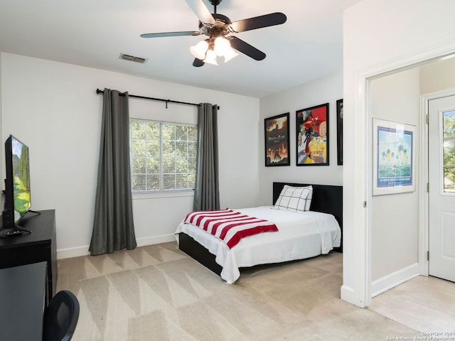 carpeted bedroom with ceiling fan and multiple windows