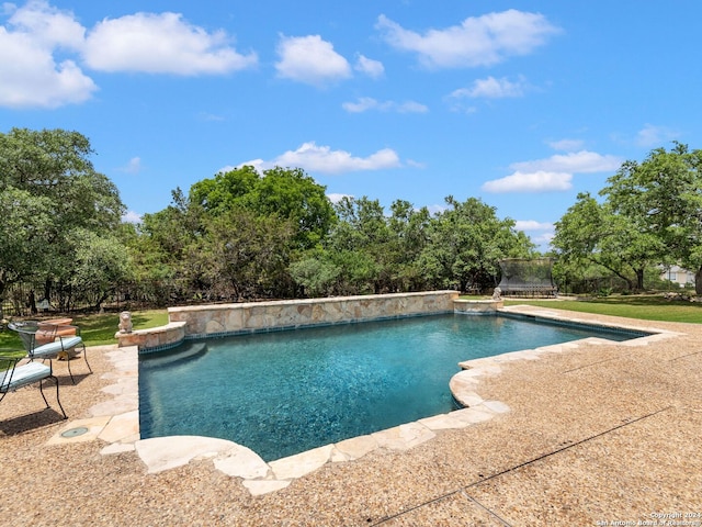 view of swimming pool featuring a trampoline