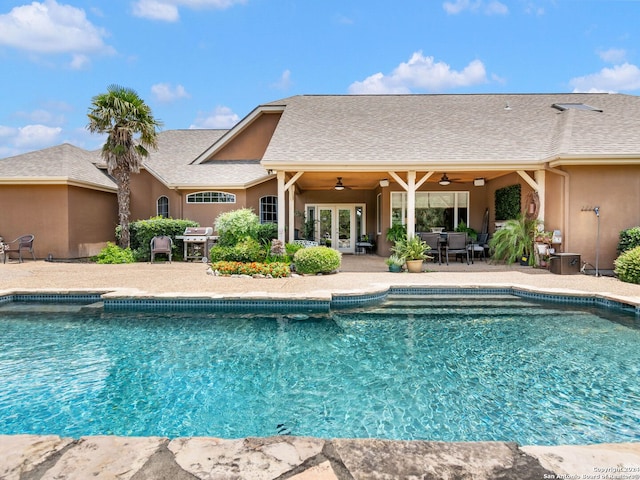 view of swimming pool with ceiling fan, a patio area, and area for grilling