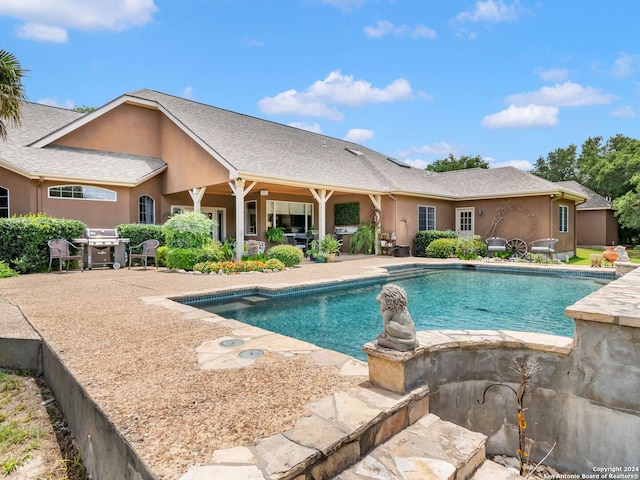 view of pool with a patio area and a grill