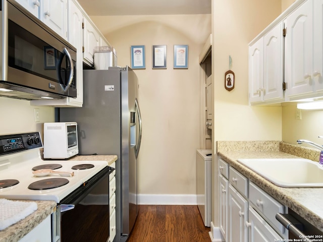 kitchen with dark hardwood / wood-style flooring, range with electric stovetop, white cabinets, and sink