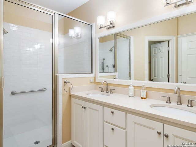 bathroom with vanity and a shower with door