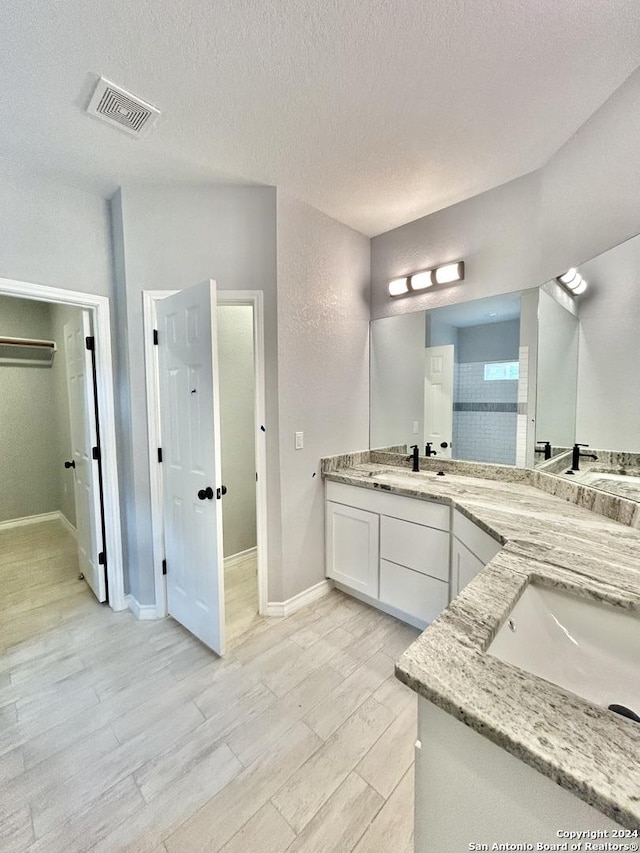 bathroom featuring vanity and a textured ceiling