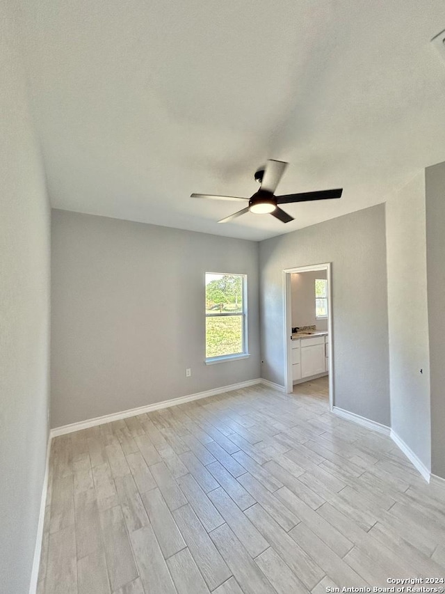 empty room with light wood-type flooring and ceiling fan