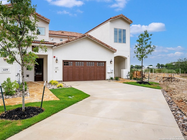 mediterranean / spanish-style house featuring a garage