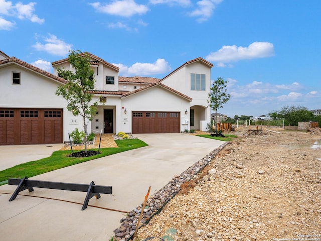 mediterranean / spanish-style house with a garage