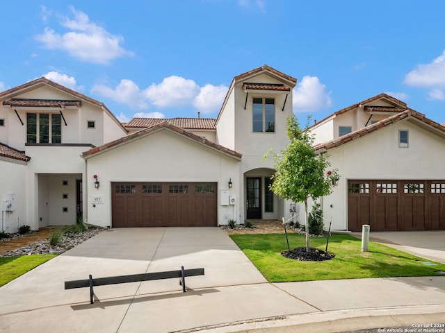 mediterranean / spanish-style home with a front yard