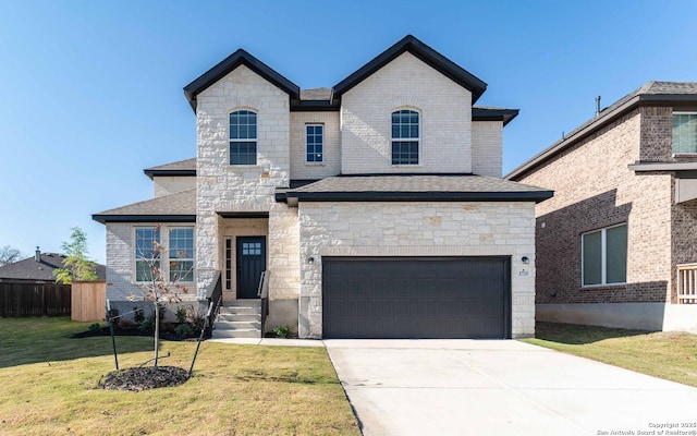 view of front of property featuring a garage and a front lawn