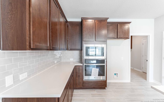 kitchen featuring decorative backsplash, dark brown cabinetry, stainless steel appliances, and light hardwood / wood-style flooring