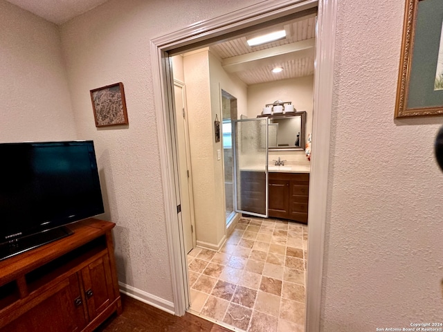 bathroom featuring walk in shower, tile flooring, and vanity