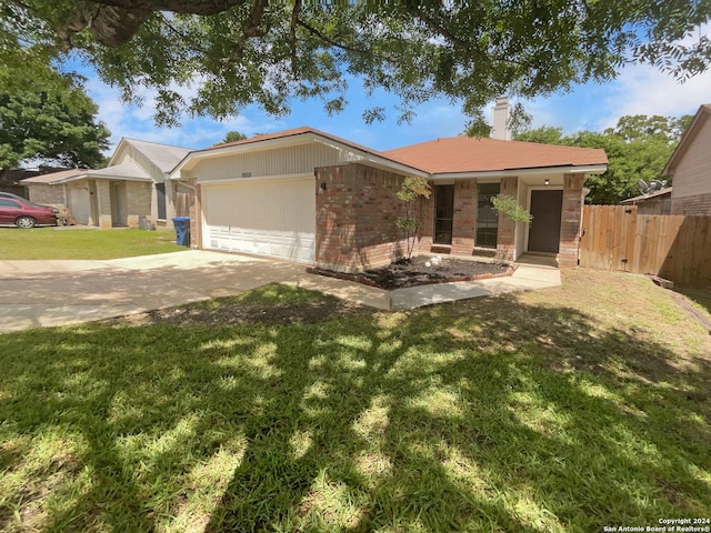 ranch-style home with a front yard and a garage