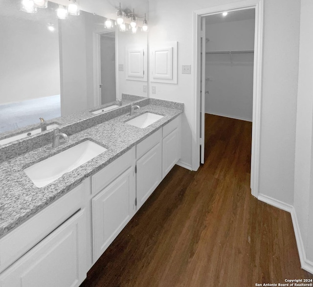 bathroom with vanity, a notable chandelier, and hardwood / wood-style flooring