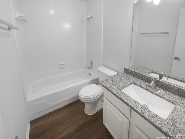 full bathroom with hardwood / wood-style floors, vanity, toilet, and tub / shower combination