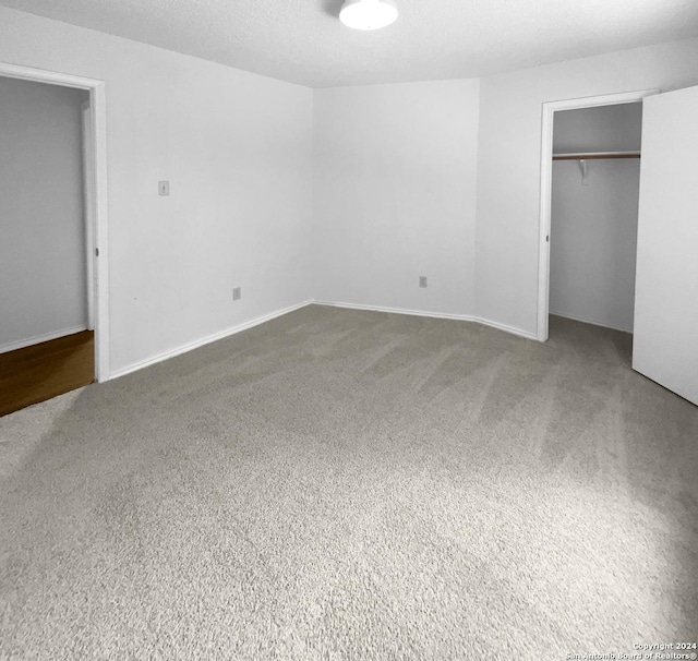 unfurnished bedroom featuring carpet floors and a textured ceiling