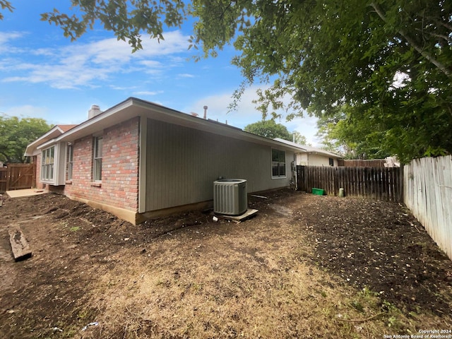 back of house featuring central AC