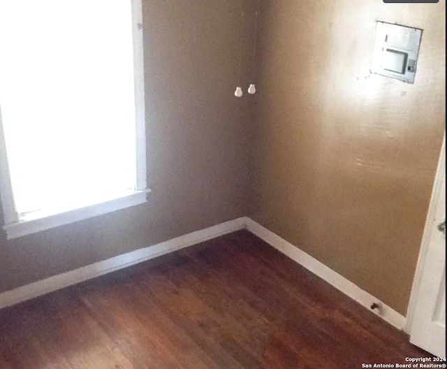 empty room with dark hardwood / wood-style floors