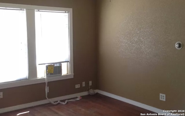 unfurnished room with wood-type flooring