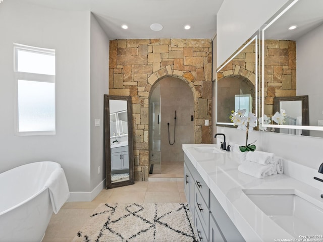 bathroom featuring dual vanity, plenty of natural light, tile flooring, and shower with separate bathtub