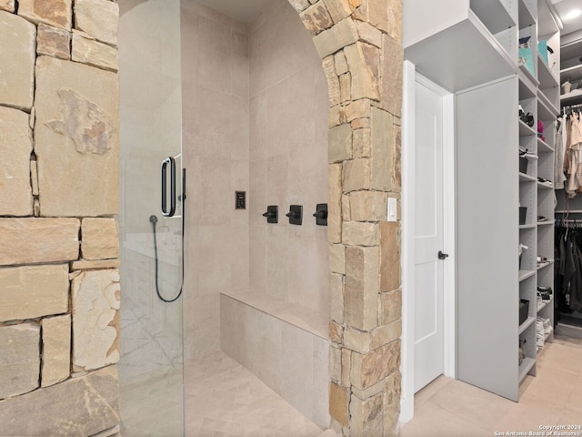 bathroom featuring walk in shower and tile floors