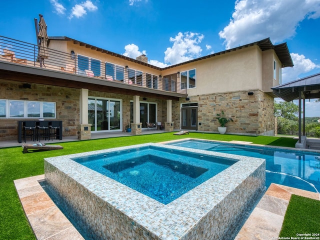 view of pool featuring a patio and an in ground hot tub